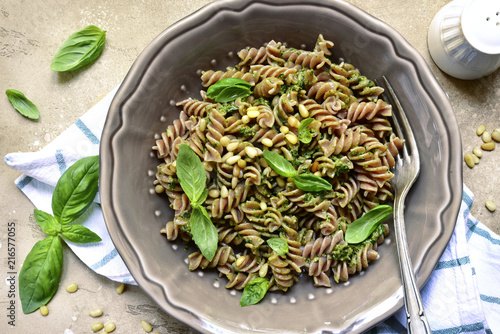 Delicious whole wheat pasta fusilli with basil pesto and pine nuts.Top view.