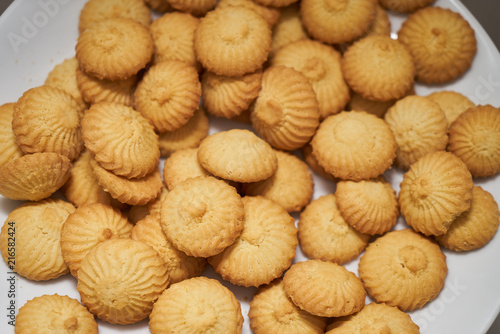 Cookies and sweet biscuits on white plate background, top view 