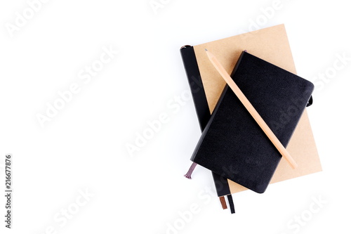 Top view cover note book with cream or natural color and leather black color with pencil placed on white background, space for letter type. Isolated , Copy space.
