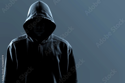 Thief in black clothes on grey background