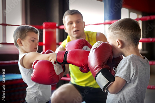 Little boys fighting in boxing ring