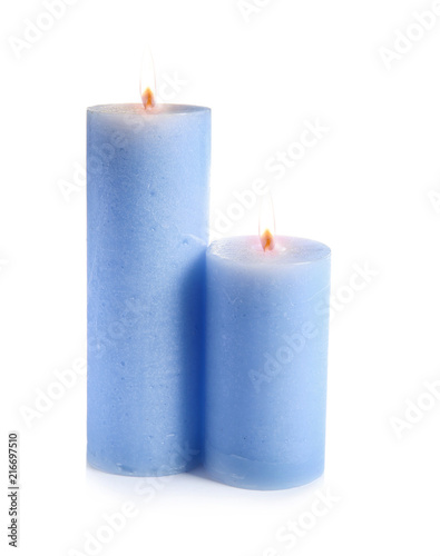 Two decorative blue wax candles on white background