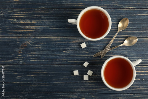 Flat lay composition with delicious tea on wooden background