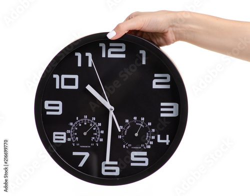Wall black clock in hand on white background isolation