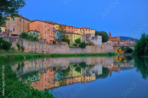 Old city reflection in Tevere river, Umbertide, Italy