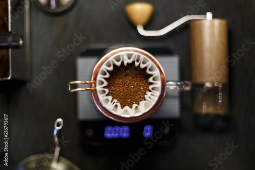 Delicious freshly ground morning coffee powder in the coffee filter. View from above