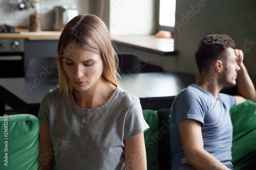 Sad depressed wife feeling upset after fight with husband, disappointed frustrated millennial girlfriend and boyfriend avoiding talk, couple tired of bad relationships and marriage problems concept