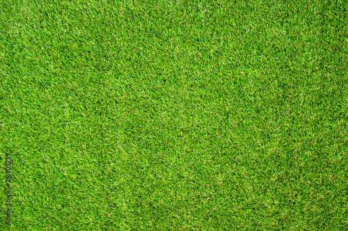Beautiful Green artificial grass background vignette or the naturally walls texture Ideal for use in the design fairly. natural pattern texture fresh spring from golf course or soccer field.