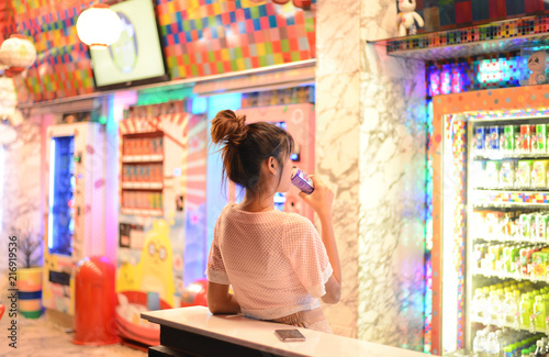 Roiet, Thailand - 26 Dec, 2016 : an unidentifed woman posting in front of Colorful Japanese vending machines