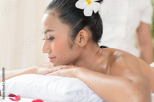 Spa Stone Massage. Young woman getting hot stone massage
