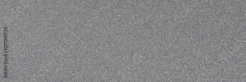 Background of gray granite with a texture of black and white spots.