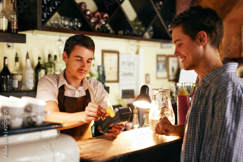 Customer Paying With Credit Card In Cafe