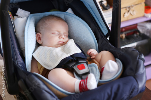 Cute little boy is sitting in carseat