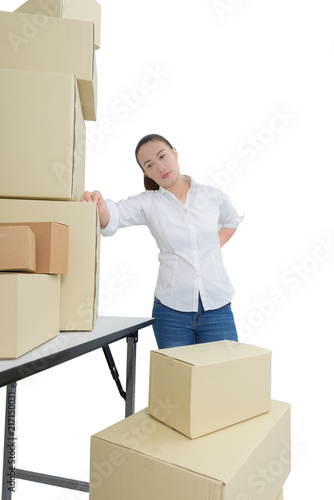 woman suffering from backache while moving boxes isolated on white background