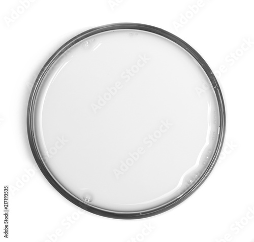 Milk puddle with bubbles in glass isolated on white background, top view
