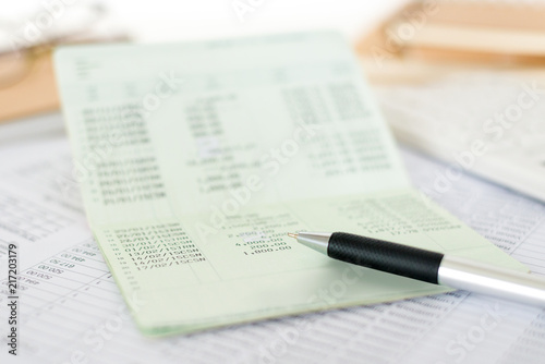 Close up of saving account passbook with pen and statement. Business and financial analysis concepts.