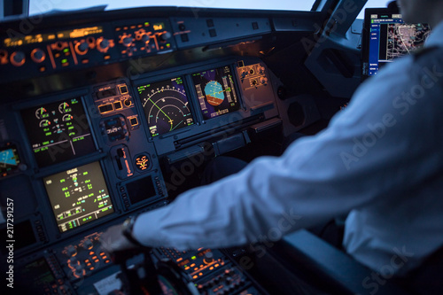 Pilot's hand accelerating on the throttle in a commercial airliner airplane flight cockpit during takeoff