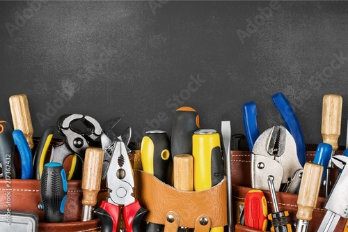 Tool belt with tools on wooden background