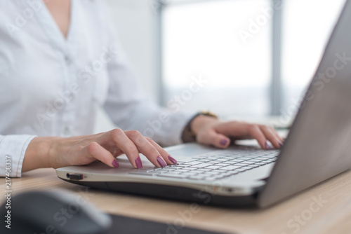 Working with laptop woman writing a blog. Female hands on the keyboard.