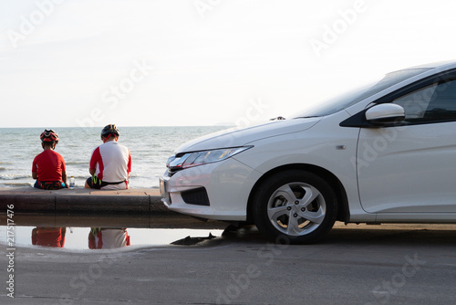 Father and he son take a brake on the beach neary thay car