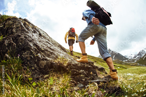 Group of hikers on a mountain. Young people on mountain hike at sunrise.