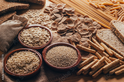 Wooden table full of fiber-rich wholegrain foods, perfect for a balanced diet