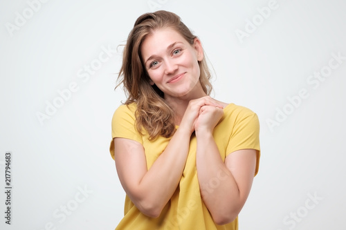 Pleased caucasian woman smiling broadly, glad to receive compliments from friends