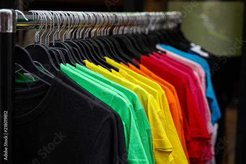 Colorful t-shirt for the man on hangers in a retail shop