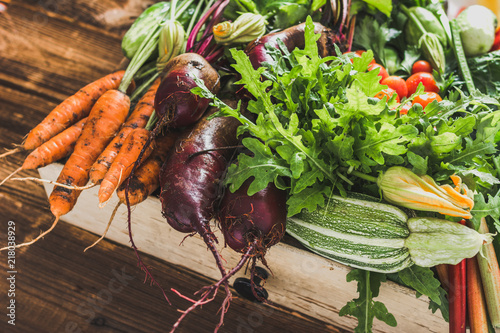 Bio organic vegetables on farmer market, farm fresh vegetable box on wooden background, vegetarian food concept