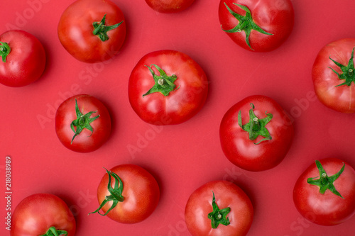 red tomatos on color background