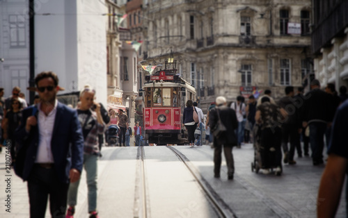 Travel in Turkey. Retro red tram and people walking by the Istiklal street near Taksim square
