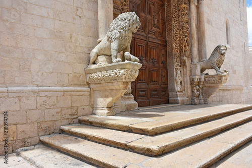 Italy, Puglia region, Altamura, Cathedral of Santa Maria Assunta, gate and sculptures of the main façade. Medieval steps at the entrance