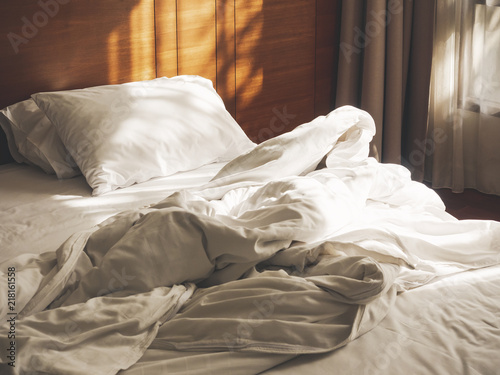 Bed Mattress and Pillows unmade Bedroom Hotel Morning with sunlight