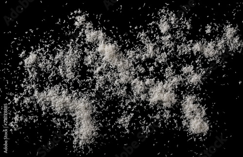 Pile of shredded coconut meat isolated on black background, top view