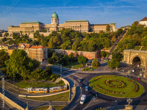 Budapest, Hungary - Clark Adam square roundabout from above at sunrise with Buda Castle Royal Palace and Tunnel and traditional yellow tram