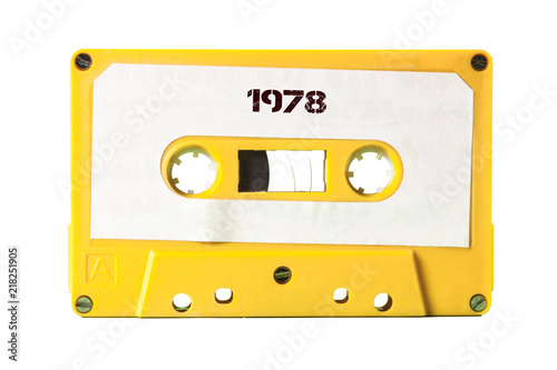 A vintage cassette tape from the 1980s era (obsolete music technology) with the text 1978 printed over it (my addition, not in the original image). Color: happy bright yellow. White background. 