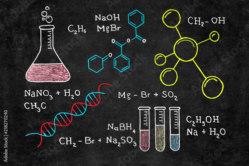 Handwritten chalk chemical formulas, DNA code, chemical flasks on school blackboard. Back to school background.