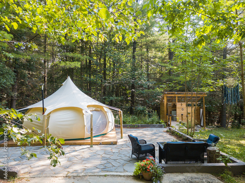 Aerial drone shot of a glamping tent in a forest