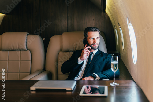 Businessman flying on his private jet. Business man flying on the private airplane. Working during the flight to his meeting. Concept about transportations and salespeople 