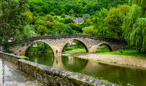Belcastel medieval bridge with Aveyron river and green forest background , Aveyron, France