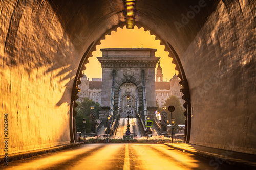 Budapest, Hungary - Entrance of the Buda Castle Tunnel at sunrise with Szechenyi Chain Bridge and Academy of Science building at background