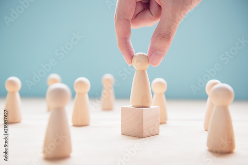 Successful team leader, Businessman hand choose people standing out from the crowd.