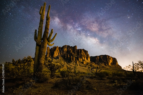 A starry night time desert landscape with the milkyway. Milkyway rising behind the superstition mountains. Arizona