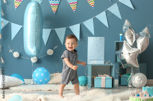 Cute little boy in room decorated for birthday party