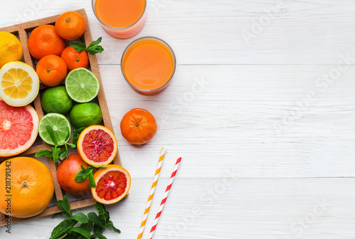 Citrus fruits and glass of fresh juice