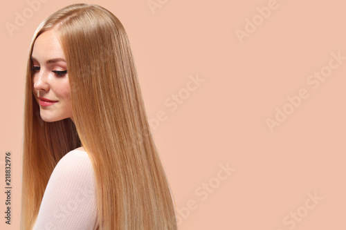 Beautiful Blonde Woman Beauty Model Girl with perfect makeup and long straight hair on light copyspace