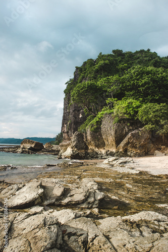 The rocky beach shore of Playa Cuevas in between Santa Teresa and Malpaís on the Nicoya peninsula of Costa Rica