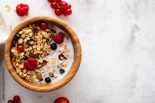 Homemade granola in bowl rustic background. Copy space.