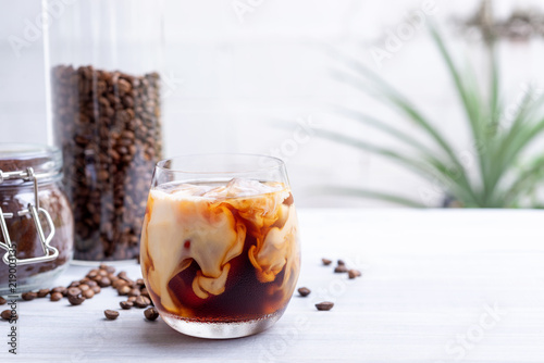 cold brew coffee with milk on white wooden table