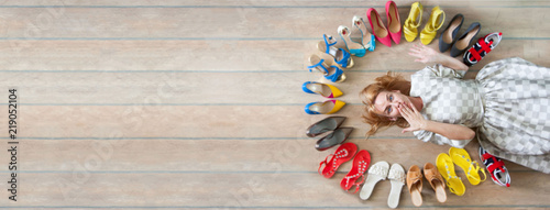 Woman choosing shoes. Colored shoes are exposed in a circle.